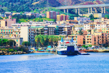 Passenger ferry in Mediterranean Sea and cityscape of Messina Sicily