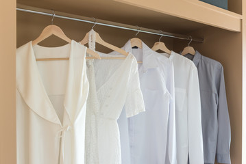 white color shirts hanging on rail