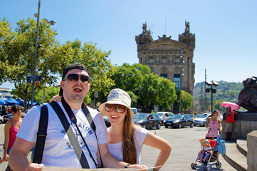 Young couple with touristic map smiling in Barcelona