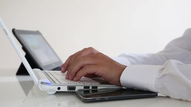Using laptop writing online and tablet