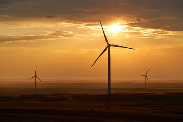 Obraz premium Wind power stations. Wind power is the use of air flow through wind turbines to mechanically power generators for electric power. 