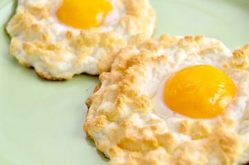 Two cloud eggs on a light green plate