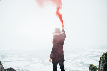 Rear view of hipster girl with smoke bomb