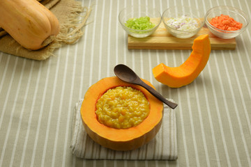 risotto with pumpkin in a crock bowl
