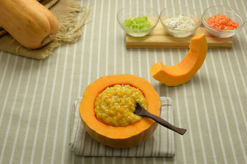 risotto with pumpkin in a crock bowl

