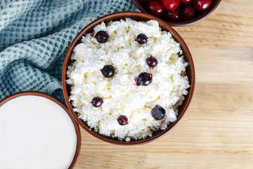 Cottage cheese on a wooden table close up