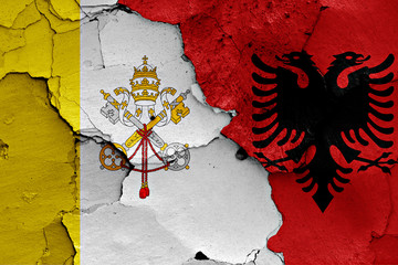 flag of Vatican and Albania painted on cracked wall