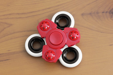Two spinners on a wooden background. Red and white spinners. Toys
