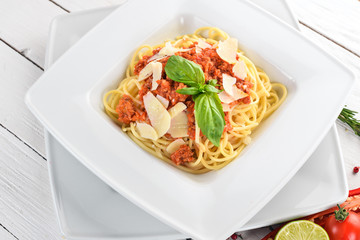 Italian cuisine. pasta with tomatoes and parmesan cheese. On a wooden background. Top view. Copy space.