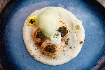 Grilled scallops with caviar and molecular froth