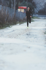 Woman doing sport in the open air, on rainy day