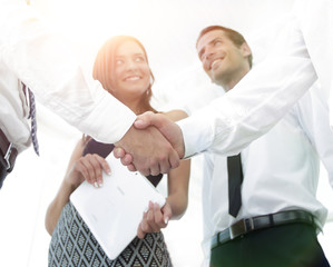 background image of handshake of business partners.