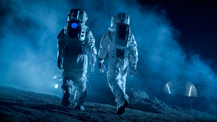 Shot of Two Astronauts in Space Suits on Alien Planet Walking Toward Rover and Geodesic Dome. High-Tech Space Exploration Concept. Manned Mission Searching and Discovering New Habitable Planets.
