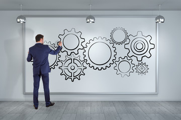 Businessman drawing gears sketch on a board 3D rendering