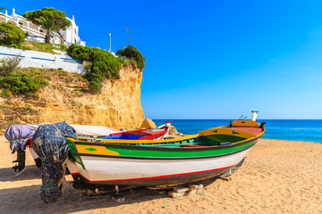 Fototapeta na wymiar Fishing boats on beach in Carvoeiro town in Algarve region, Portugal