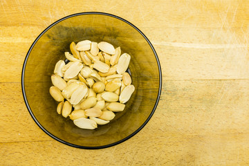 Bowl with shelled peanuts. View from above.