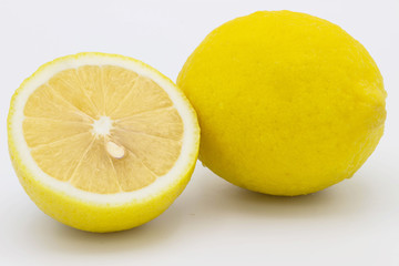 Group of ripe whole yellow lemon citrus fruit with lemon fruit half  on white background