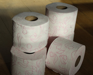 Stack of toilet paper rolls on wooden background
