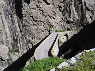 St. Gotthard Teufelsbruecke, alpine Devil's road bridge over Reuss river near Andermatt town in...