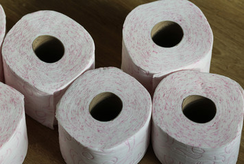 Stack of toilet paper rolls on wooden background