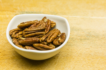 Bowl with shelled pecan nuts.