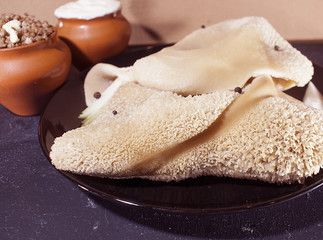 Boiled beef stomach with buckwheat porridge and sour cream. The view from the top.