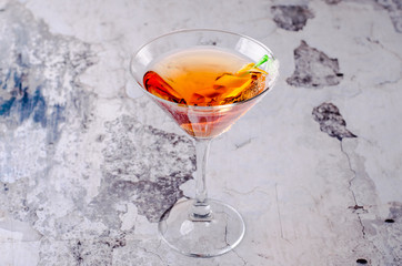 Top view red orange cocktail margareta fresh in a martini glass on a gray background. Bar alcohol drink menu, delicious tequila sunrise long drink for party.