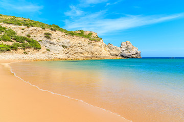 Fototapeta na wymiar Calm sea water on beautiful Barranco beach on sunny beautiful day, Algarve, Portugal