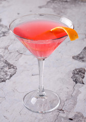 Top view red orange cocktail margareta fresh in a martini glass on a gray background. Bar alcohol drink menu, delicious tequila sunrise long drink for party.