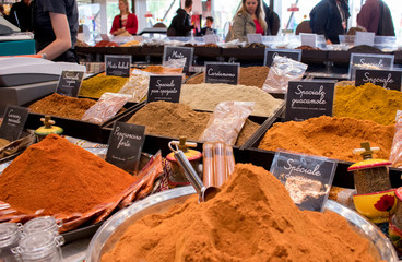 spice market at the gastronomic exhibition, on black  plates name spices in Italian  language ...
