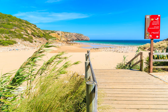 ZAVIAL BEACH, PORTUGAL - MAY 15, 2015: Wooden walkway to beach on sunny summer day. Algarve region is very popular holiday destination in southern Europe.