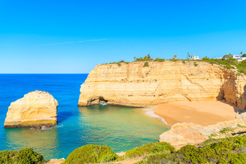 A view of secluded beautiful beach and cliffs on coast of Portugal near Carvoeiro town