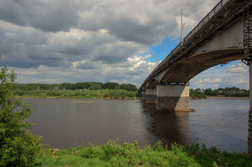  bridge to the opposite bank of the river, under the cloudy sky in the spring