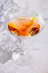 Top view red orange cocktail Margarita fresh in a martini glass on a gray background. Bar alcohol drink menu, delicious tequila sunrise long drink for party.