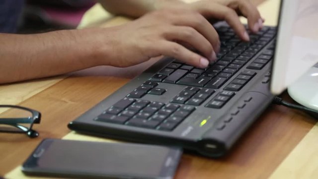 Computer keyboard typing online in wood desk
