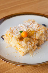 Napoleon cake on a white plate with berries