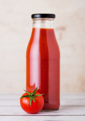 Glass bottle of tomato paste with raw  tomato