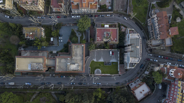 Orthogonal aerial view of a suburb of the city of Rome. The buildings are modern and urban planning is also futuristic. So many are the trees planted around the houses.
