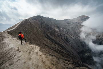 Traveler at crater volcano at Bromo (Gunung Bromo) an active volcano in the Bromo Tengger Semeru...