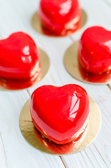Delicious cakes in the form of glossy red hearts.
