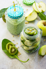 Green smoothies and  apple, kiwi, spinach, pine nuts. Healthy vegan food concept. Copy space.