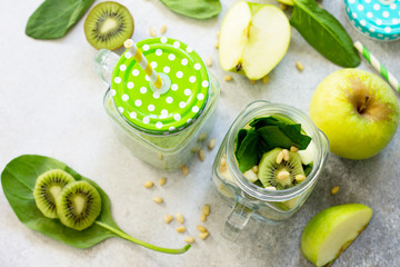 Healthy vegan food concept. Proper nutrition. Green smoothies and  apple, kiwi, spinach, pine nuts.