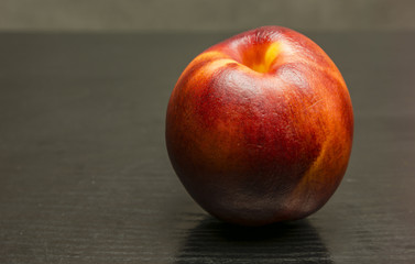 Nectarine on a wooden background.