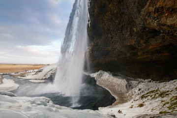 behind seljalandsfoss waterfall in Iceland