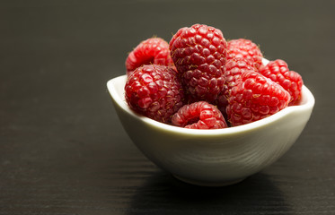 Red-fruited raspberries in bowl.
