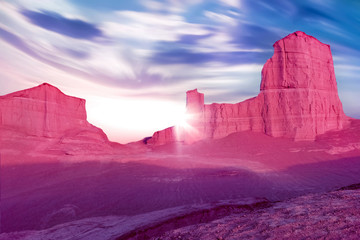 Pink rocks in the desert against a beautiful blue sky with clouds. Alien planet concept. Iranian...