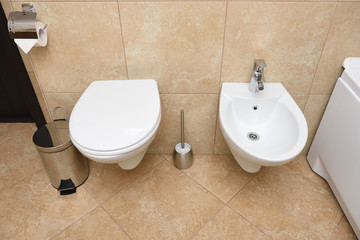 Beautiful bathroom with bidet and toilet bowl in white color
