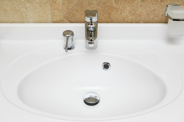 Beautiful white washbasin with built-in soap dish for liquid soap