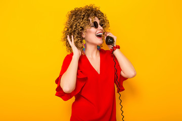 Attractive woman with short curly hair with phone