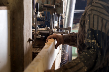 Carpenter using electric saw
